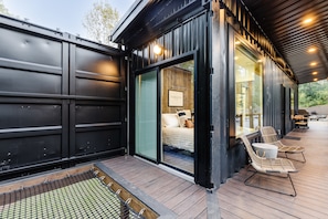 Sliding door in the bedroom opens right up onto the deck! Step outside and into the sunk in hammock!
