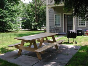 Outdoor dining in rear patio w/ gas grill