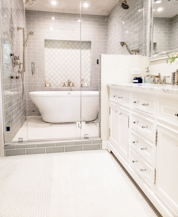 Master bath oversized wet room including steam, dual shower, freestanding tub