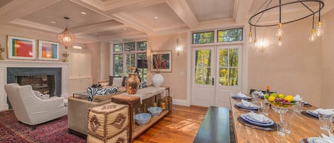 Living Room - An elegantly furnished living room with gas fireplace opens to an outdoor patio with a perennial stream Cornet Creek