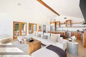 Expansive sofa with large flat screen TV.