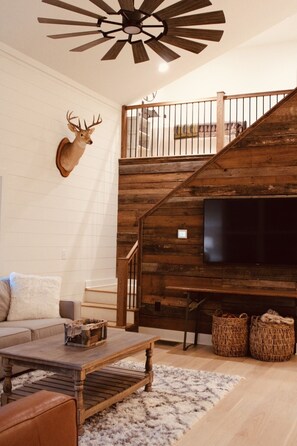 Open concept living room and stairs.