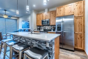 Kitchen - Large granite top kitchen island seating for 5.