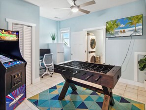 Spend your evenings in the Ground-Level Game Room with the Laundry Room, additional refrigerator, and Arcade Gaming System.