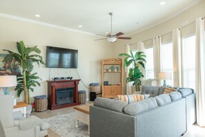 Spacious Living Room - Large comfortable couches, a flat screen TV, and ceiling fan so you can enjoy your evenings with family and lots of breathing space.