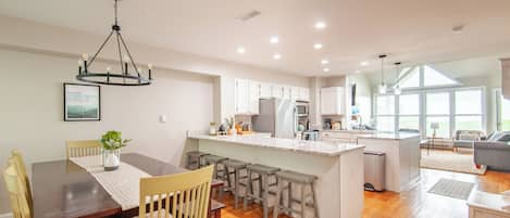 Main living floor contains dining, kitchen, living room, and half bath.