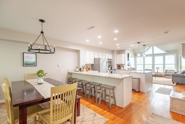Main living floor contains dining, kitchen, living room, and half bath.