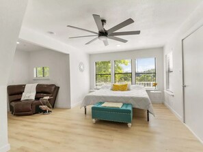 Master bedroom with king size bed,  Roku TV, plenty of light and sitting area