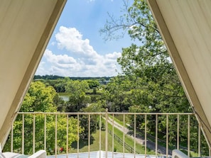 View from the top balcony w/patio chairs overlooking the lake & mature trees