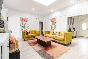 Colorful Mid century modern interior with bar and 55-70” 4k TV’s 