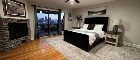 Beautiful master bedroom includes 55” smart TV, plush queen bedding, modern fan.