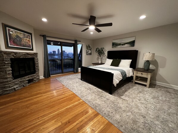 Beautiful master bedroom includes 55” smart TV, plush queen bedding, modern fan.