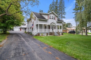 Viewing the driveway and front lawn. A much more spacious yard is located to the left. The driveway stretches to Park Ave, great for trailers.