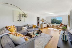 Bright and airy living room with large windows and mountain views