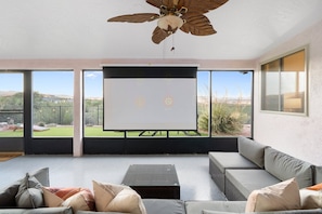 Watch a movie from the comfort of the Rec Room sofa feeling the outdoor breeze!