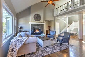 Formal living room with gas fireplace and vaulted ceilings