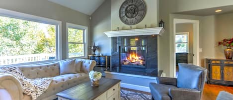 Formal living room with gas fireplace and vaulted ceilings