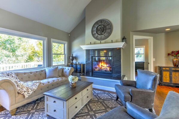 Formal living room with gas fireplace and vaulted ceilings