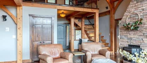This luxurious custom home is full of character with exposed wood beams, soaring windows, and a bright open floor plan.