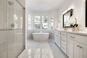 Master bathroom with separate shower and soaking tub. Perfect to unwind or bathe the kids!