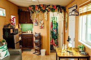 Darling bathroom and kitchenette dripping with tropical blooms
