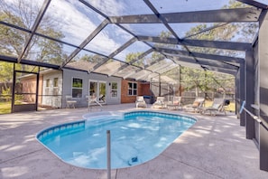 The screened-in saltwater pool and patio area is the perfect place to relax.