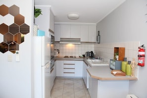 Full kitchen, with microwave, full-sized fridge, wall oven, grill and stove-top. Plus tea and coffee essentials.