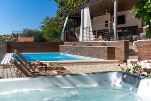 Traditional stone house near Sinj with open views of the river valley of Cetina.