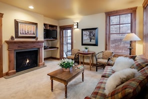 Living room with Gas fireplace. Please note this space doubles as a guest room with murphy bed