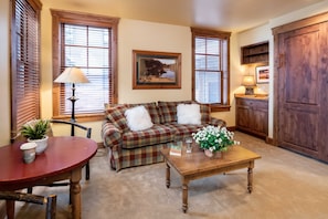 Living room with Gas fireplace. Please note this space doubles as a guest room with murphy bed