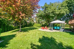 Escape to your private oasis—a big, fenced backyard with a gazebo and firepit
