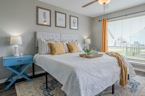 Relax in the spacious master bedroom featuring a comfy king bed, bedside charging tables, and stunning ocean views. Enjoy ultimate comfort with an ensuite bathroom, perfect for a peaceful retreat near the beach.
