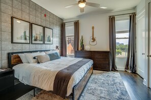 Master bedroom with King size bed, designer furnishings and flat screen TV.