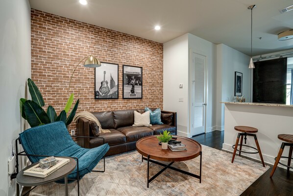 Urban style living room with designer furnishings and flat screen TV.