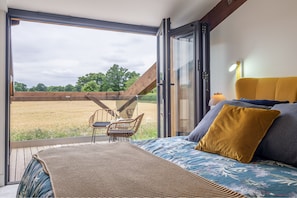 1 Long Barn, Henham: Master bedroom with balcony featuring views across the surrounding fields