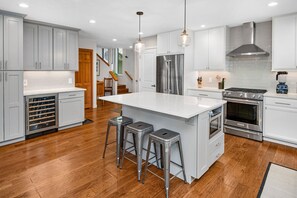 Kitchen with breakfast bar, stainless steel appliances and a win