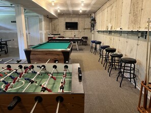 Shared game room in the garage. Foosball, pool table, air hockey and more!