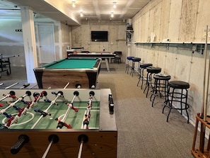 Shared game room in the garage. Foosball, pool table, air hockey and more!