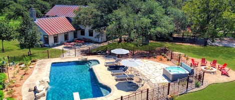 Aerial view of the rear of the main house with pool and hot tub.