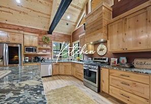 Cook up memories in this cabin's charming kitchen! Modern amenities meet rustic charm.