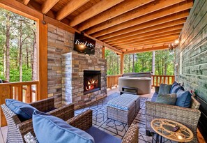 Enjoy the serene pine views from this comfortable outdoor seating area. Ideal for evening relaxation by the fire.