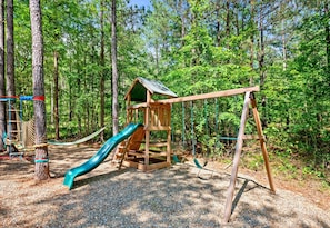 Let the kids unleash their energy on the playset while you relax in the shade of towering trees