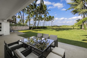 Enjoy some time in the shaded outdoor seating area with gorgeous tropical views