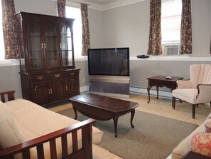 Creamery Apt 6 living room area with large screen TV.