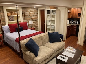 Primary bedroom with entrance to the kitchen on right and bathroom on left.