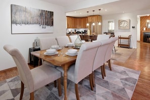 Seating for your family at this large dining table and bar space in the kitchen keeps your group together for gathering