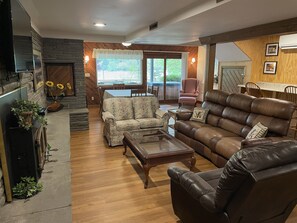 Living room and dining area overlooking water