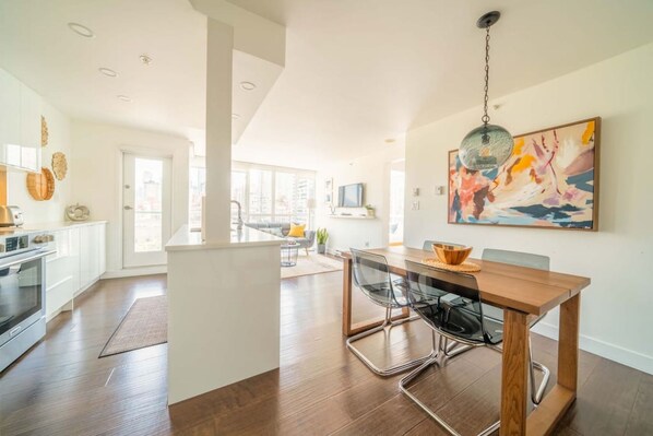 View from the entrance. Open concept kitchen, dining area and living room with stunning city, mountains and ocean view.