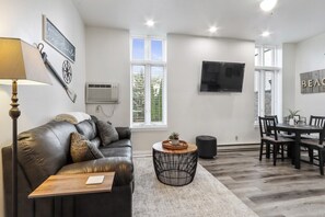 Living room with queen sofa sleeper and TV