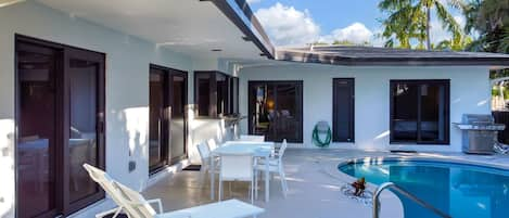 Outdoor dining table and sun loungers compliment the heated pool